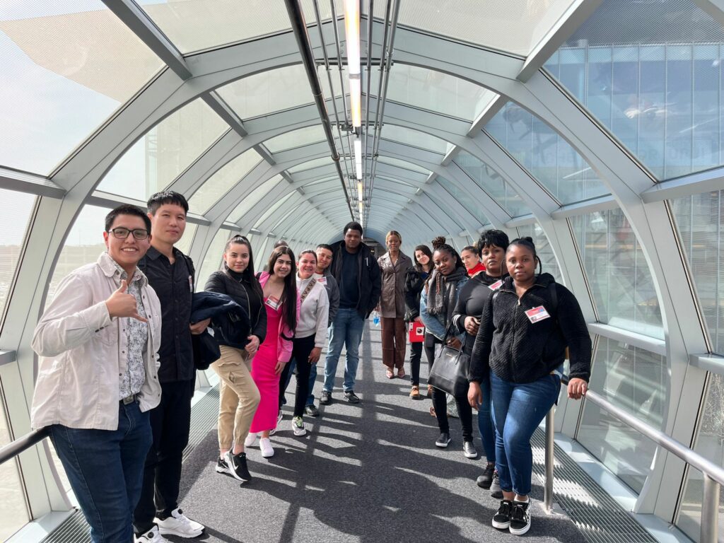 Picture of a group of people standing in a windowed tunnel on the Indiana University Indianapolis campus.